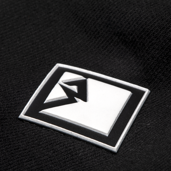 Close Up View of White Diamond R Rubber Patch on T-Shirt